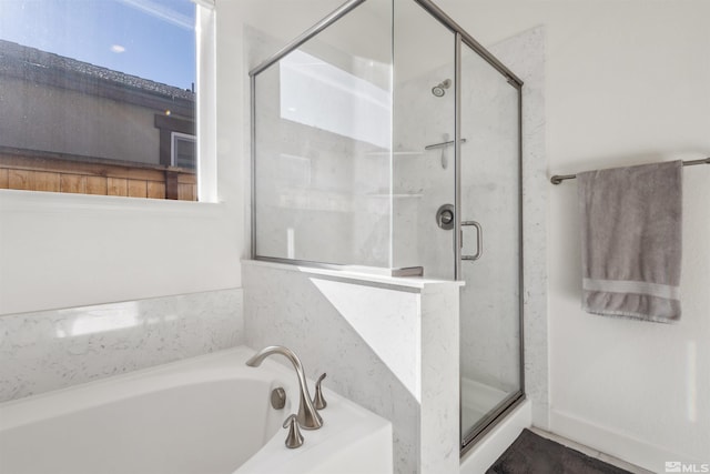 full bath featuring a garden tub and a shower stall