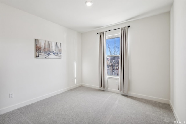 spare room with carpet flooring and baseboards