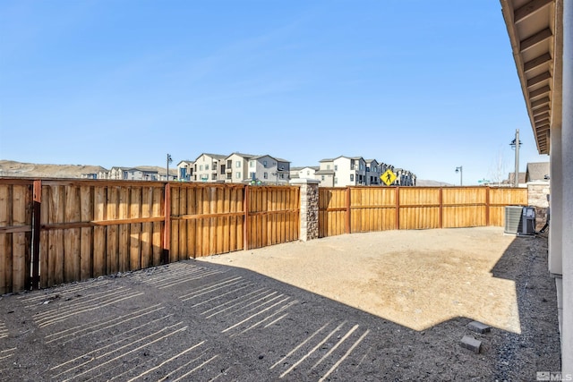 exterior space featuring a residential view, fence, and cooling unit