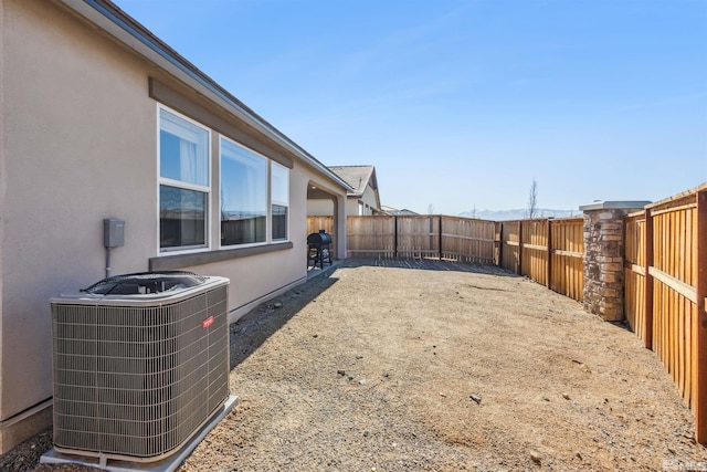 view of yard featuring central air condition unit and a fenced backyard