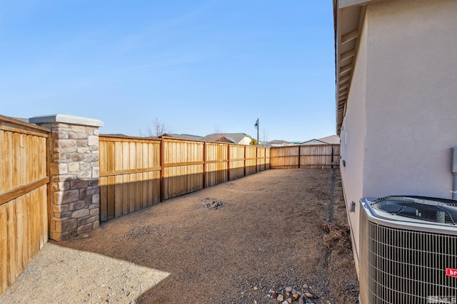 view of yard with a fenced backyard and cooling unit