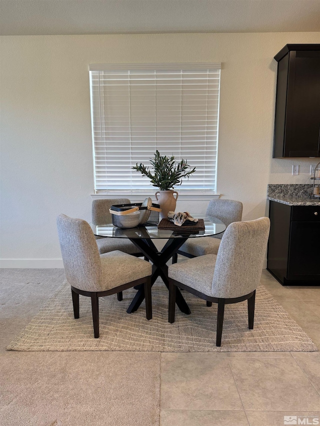 dining room featuring light tile patterned floors and baseboards