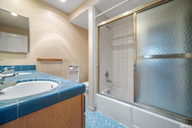 full bathroom featuring enclosed tub / shower combo, vanity, toilet, and tile patterned flooring