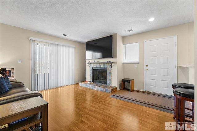 living room featuring a textured ceiling and hardwood / wood-style floors