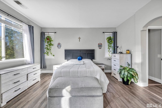 bedroom with dark wood-type flooring