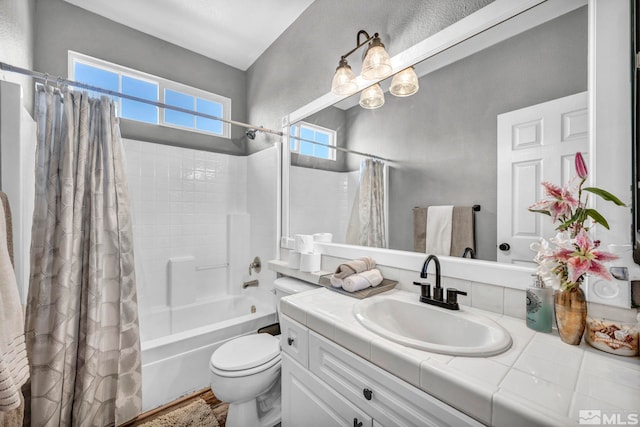 full bathroom featuring toilet, shower / bathtub combination with curtain, and vanity