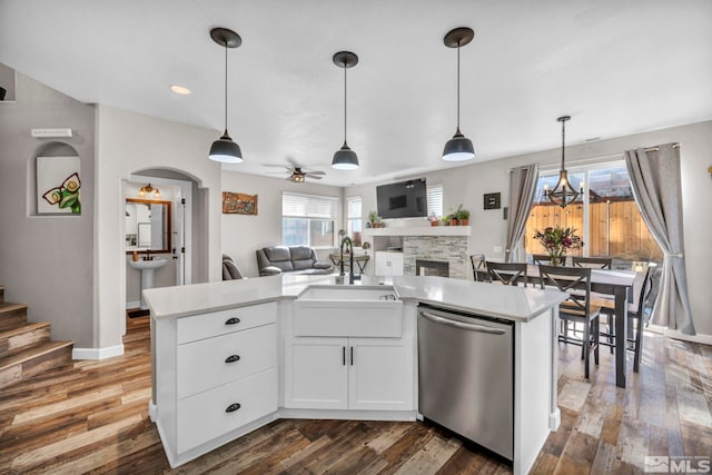 kitchen with white cabinetry, dark hardwood / wood-style flooring, sink, ceiling fan, and stainless steel dishwasher