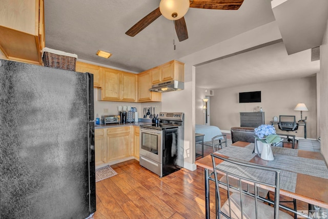 kitchen featuring light brown cabinetry, light hardwood / wood-style floors, black fridge, ceiling fan, and stainless steel electric range