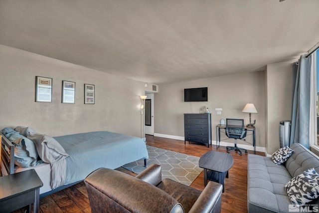 bedroom featuring dark wood-type flooring and multiple windows