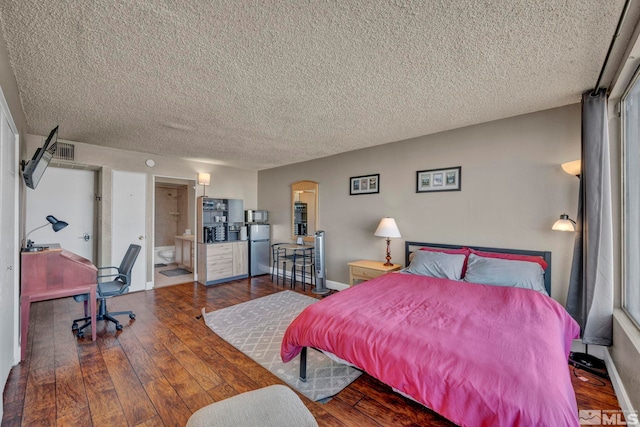 bedroom featuring a textured ceiling, ensuite bathroom, refrigerator, and dark hardwood / wood-style flooring