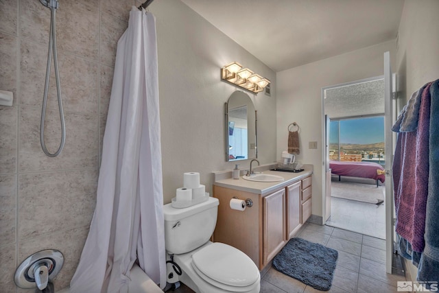 bathroom with toilet, tile patterned flooring, and vanity