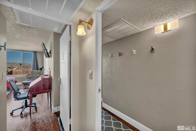 interior space featuring a textured ceiling and hardwood / wood-style flooring