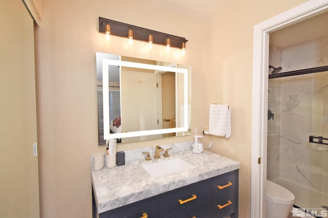 bathroom with an enclosed shower, vanity, and toilet