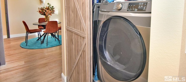 washroom featuring light wood-type flooring and washer / clothes dryer