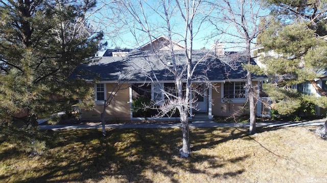 back of house with a lawn