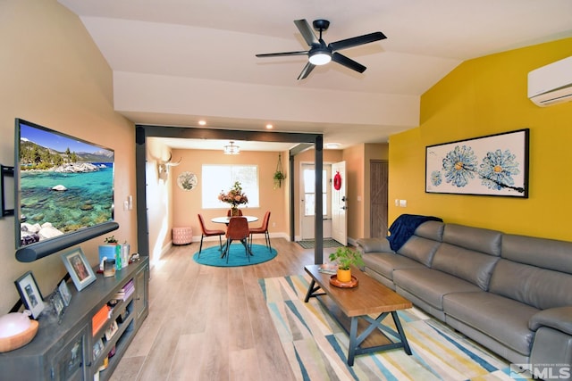 living room with an AC wall unit, light hardwood / wood-style floors, lofted ceiling, and ceiling fan