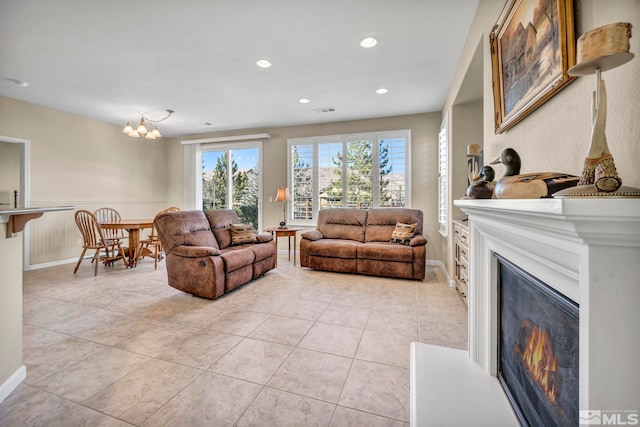 tiled living room with a notable chandelier and a wealth of natural light