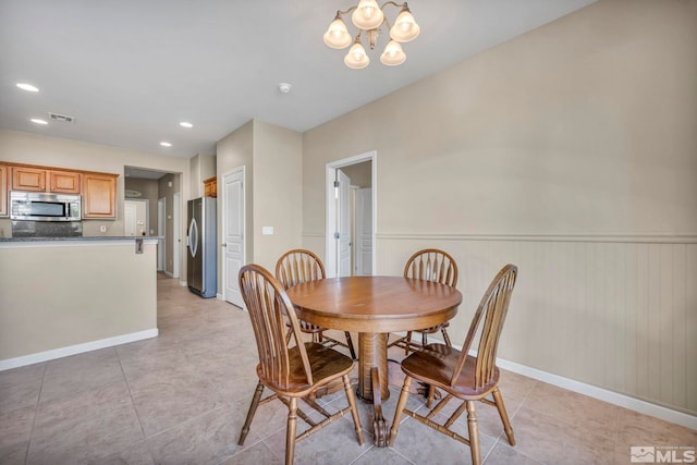 tiled dining area with a notable chandelier