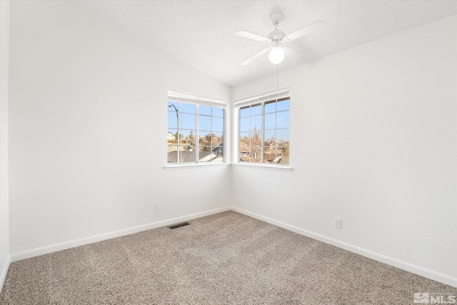 unfurnished room with ceiling fan, a textured ceiling, lofted ceiling, and carpet floors