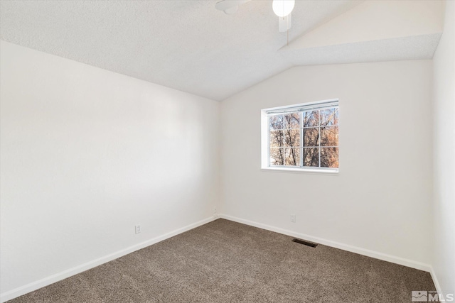 spare room with carpet floors, ceiling fan, and vaulted ceiling