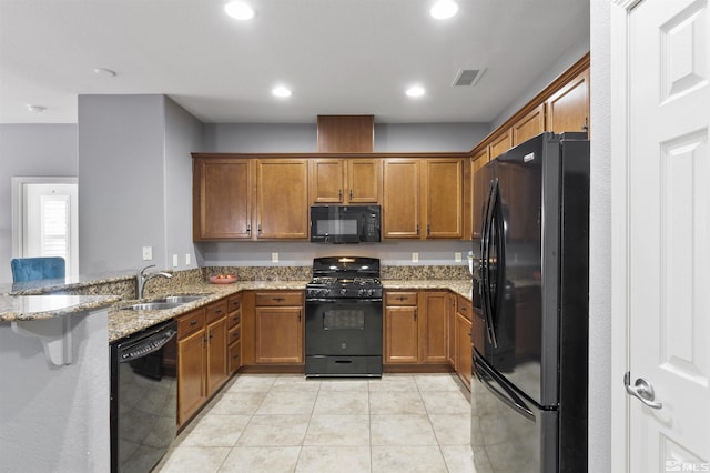 kitchen featuring black appliances, sink, kitchen peninsula, light tile patterned flooring, and light stone counters