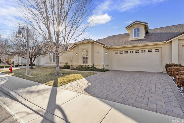 view of front of house featuring a front lawn and a garage