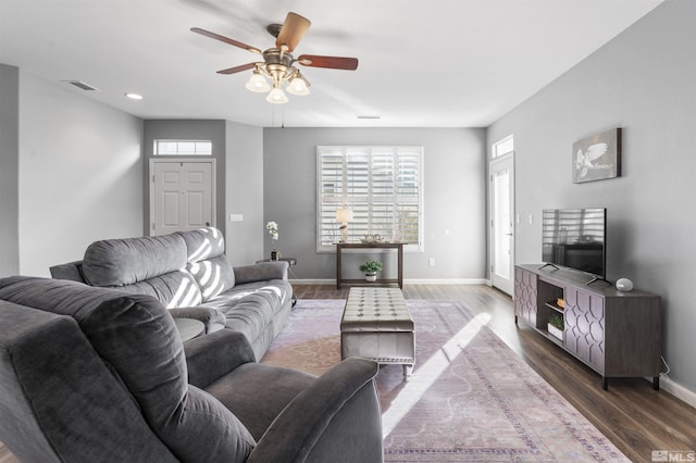 living room with ceiling fan, dark hardwood / wood-style flooring, and a healthy amount of sunlight