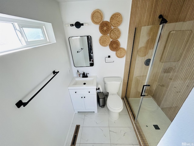 bathroom with walk in shower, vanity, and toilet