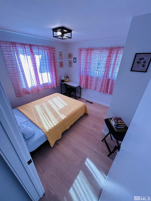 bedroom with hardwood / wood-style floors