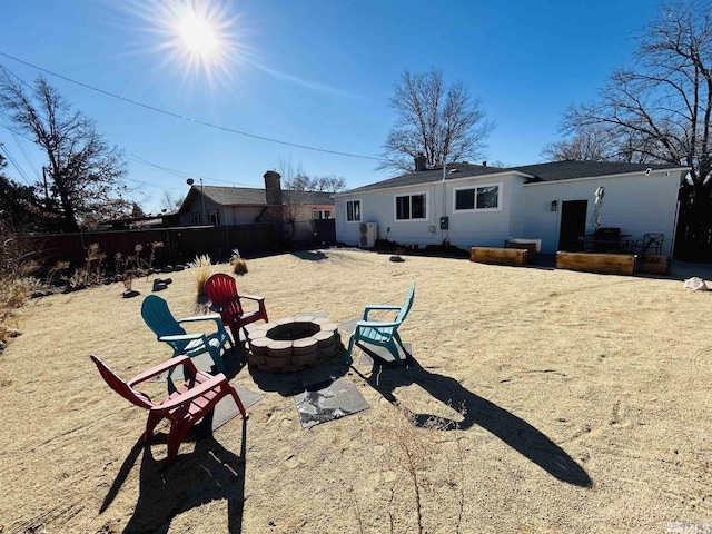 back of property featuring a patio area and a fire pit