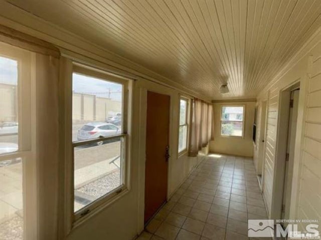 unfurnished sunroom with wooden ceiling