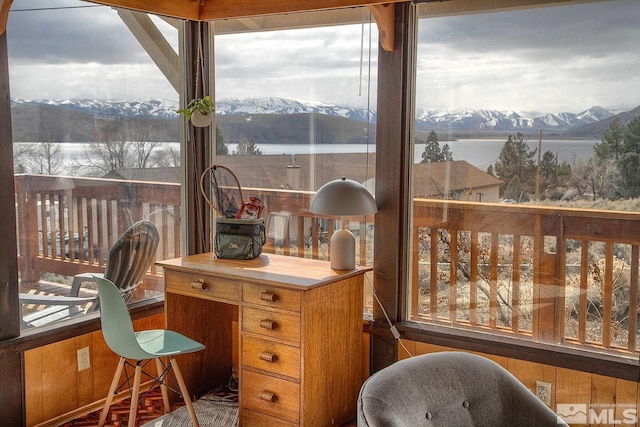 sunroom with a water and mountain view