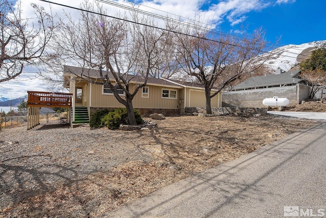 view of front of home with a deck with mountain view