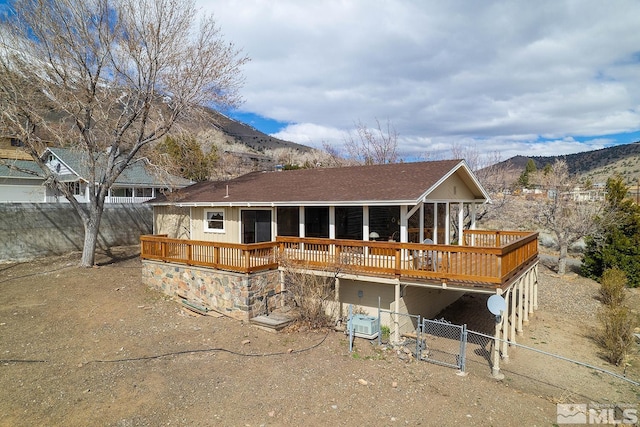 rear view of property with a deck with mountain view