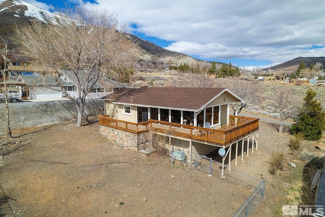 rear view of property with central air condition unit and a deck with mountain view