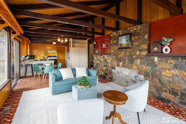 living room with wooden ceiling, vaulted ceiling with beams, and wooden walls