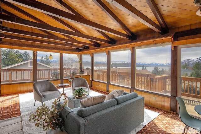 sunroom with wooden ceiling, a mountain view, and vaulted ceiling with beams