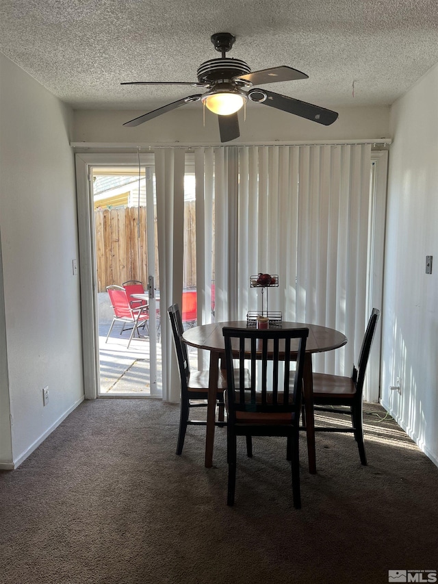 dining area featuring a textured ceiling, ceiling fan, and carpet