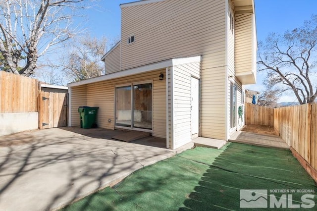 back of property featuring a patio area and a fenced backyard