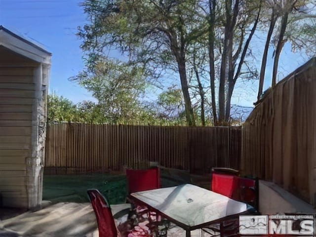 view of patio with outdoor dining area and a fenced backyard