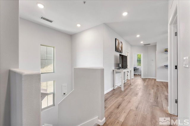 hall with light hardwood / wood-style floors