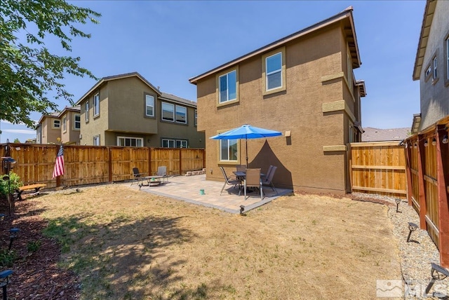 back of property with a patio