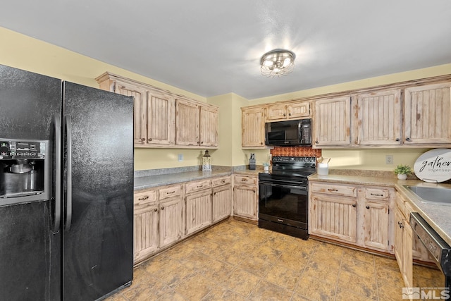 kitchen featuring sink, light brown cabinetry, and black appliances