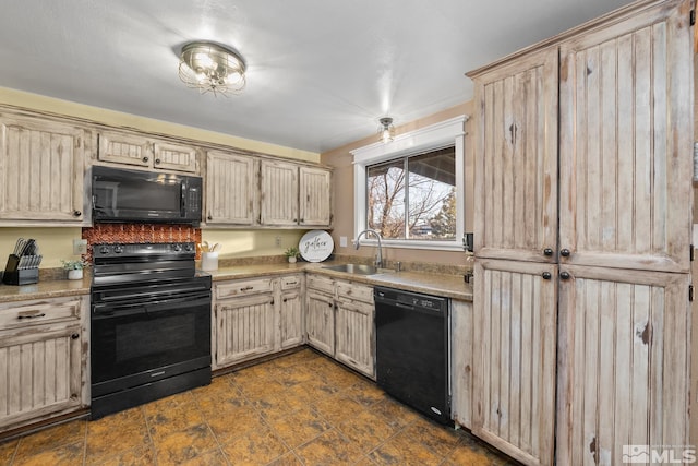 kitchen featuring sink, light brown cabinets, and black appliances