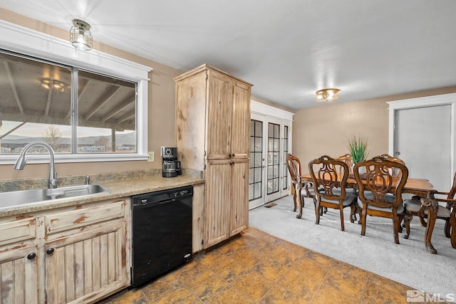 kitchen with sink, light brown cabinets, black dishwasher, and dark carpet