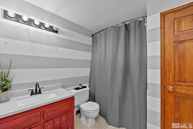 bathroom with toilet, vanity, and a shower with curtain