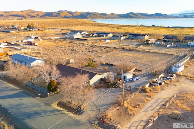 drone / aerial view with a water and mountain view