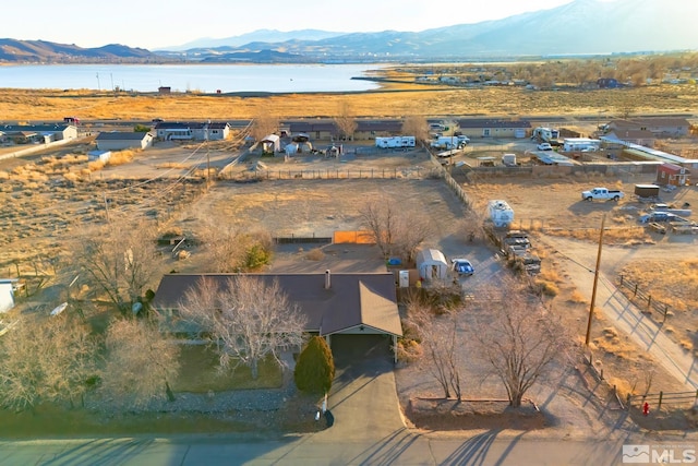 drone / aerial view featuring a water and mountain view