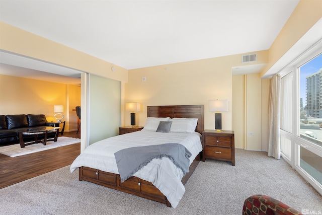 bedroom featuring light carpet