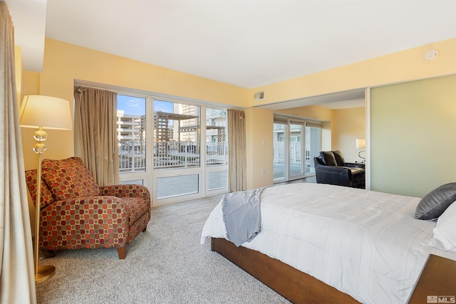 bedroom featuring access to exterior and carpet flooring